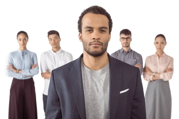 Businessman standing in front of colleagues — Stock Photo, Image