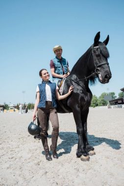 Young couple riding horse  clipart