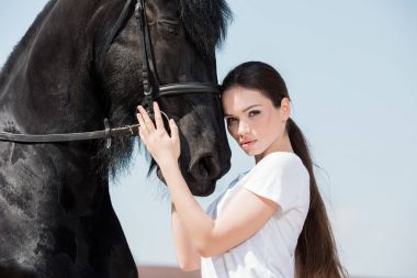 Young woman with horse  clipart