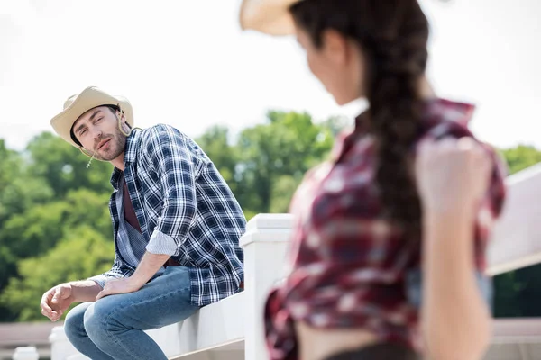 Young cowboy looking at girl — Stock Photo, Image