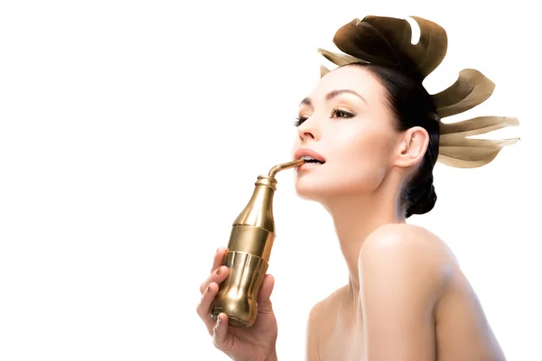 Woman with golden water bottle — Stock Photo, Image