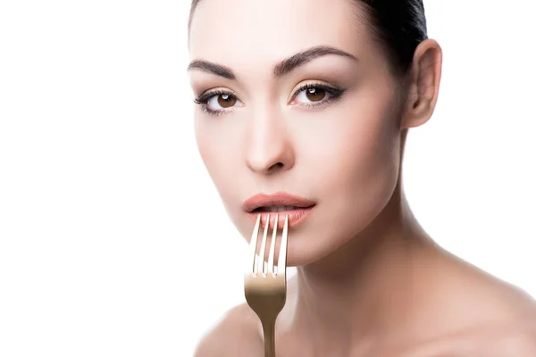 Young woman pressing fork to lips — Stock Photo, Image
