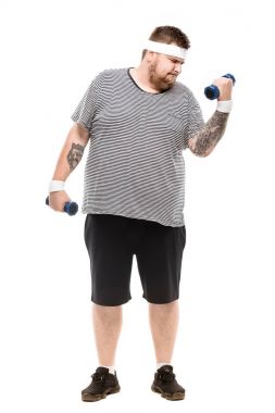 young fat man exercising with dumbbells clipart