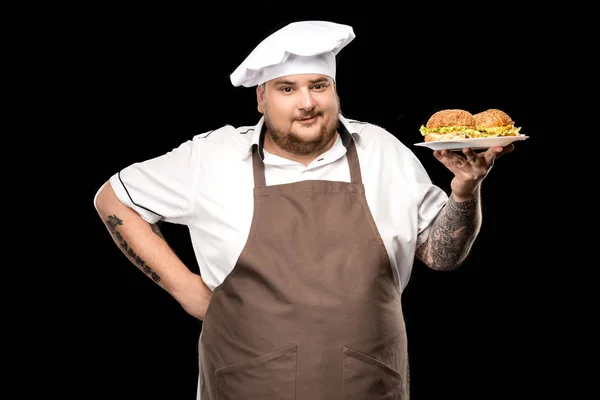 Cuisinière avec hamburgers sur plaque — Photo