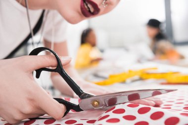 dressmaker cutting polka dot fabric clipart