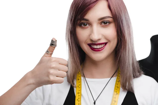 Needlewoman with thimble showing thumb up — Free Stock Photo