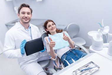 patient and dentist with tablet clipart