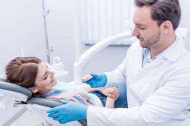 dentist showing dental mold clipart