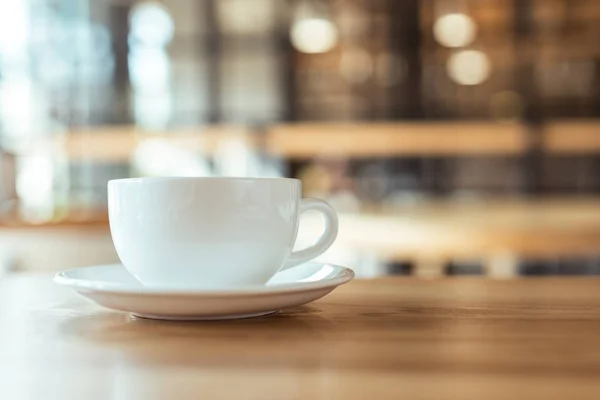 Cup of coffee on table in coffee shop — Stock Photo, Image