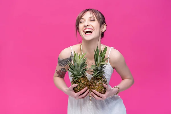 Young woman holding pineapples — Stock Photo, Image