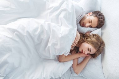 couple sleeping in bed clipart