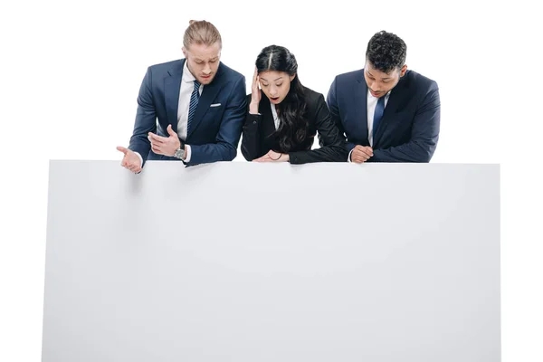 Shocked businesspeople with empty board — Stock Photo, Image