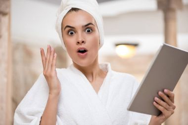 shocked woman using digital tablet clipart