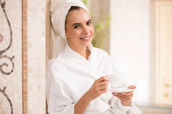 woman drinking tea after spa