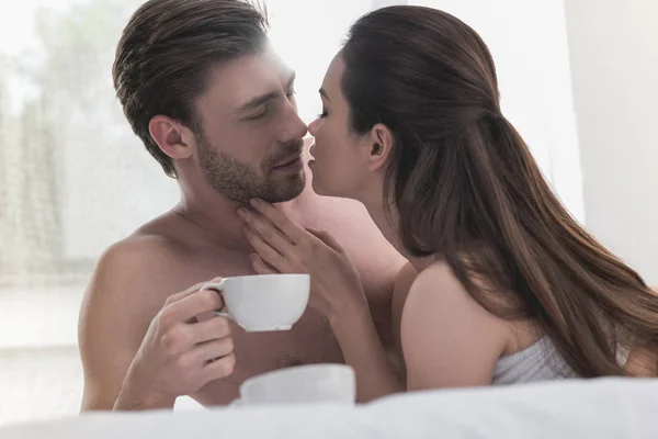 Para picia kawy w łóżku — Zdjęcie stockowe