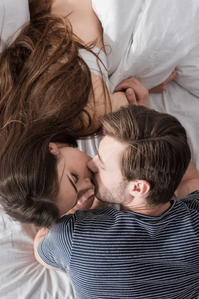 Pareja besándose en la cama — Foto de Stock