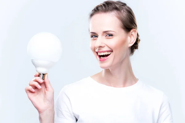 Happy woman with light bulb — Stock Photo, Image