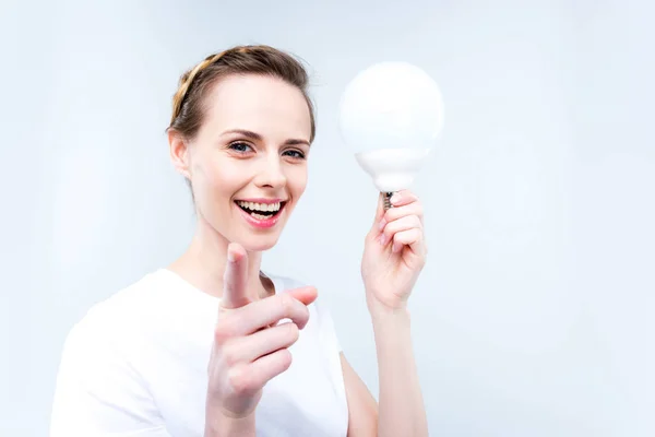 Woman with light bulb — Stock Photo, Image