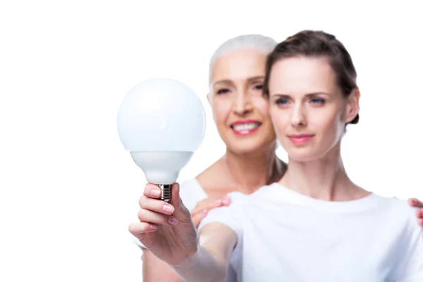 Adult daughter and mother with light bulb — Free Stock Photo