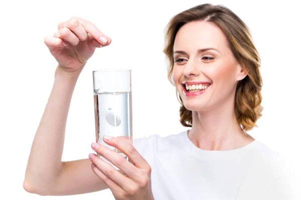 Woman with glass of water and pill — Free Stock Photo