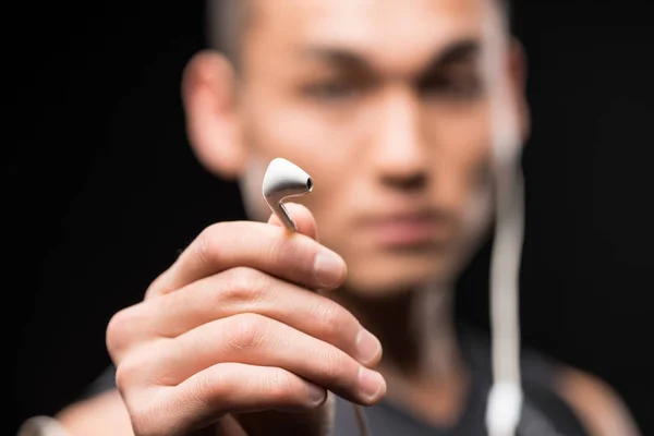 Man holding earphones — Stock Photo, Image