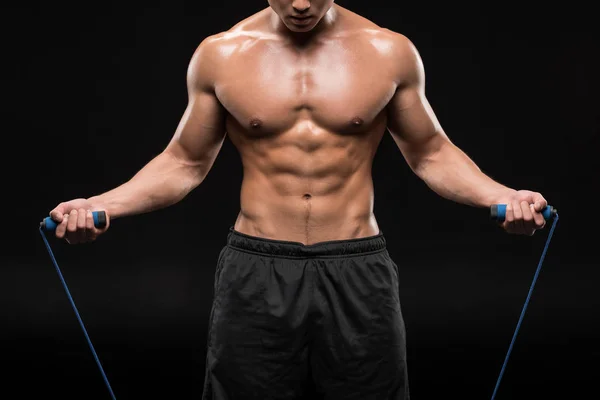 Muscular man with skipping rope — Stock Photo, Image