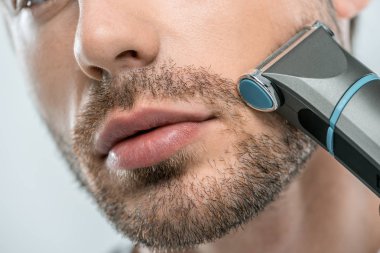 man using electric razor clipart