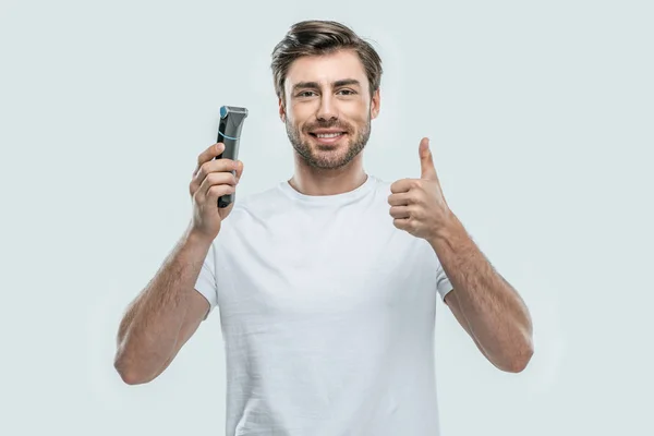 Hombre con afeitadora eléctrica —  Fotos de Stock