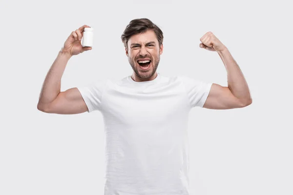 Strong man with vitamins — Stock Photo, Image