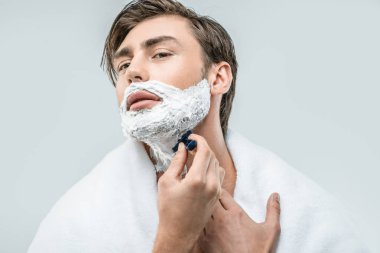man in foam shaving with razor clipart