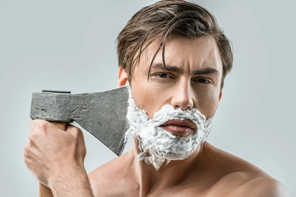 Man in foam shaving with ax — Stock Photo, Image