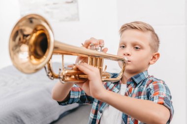 boy practicing trumpet clipart