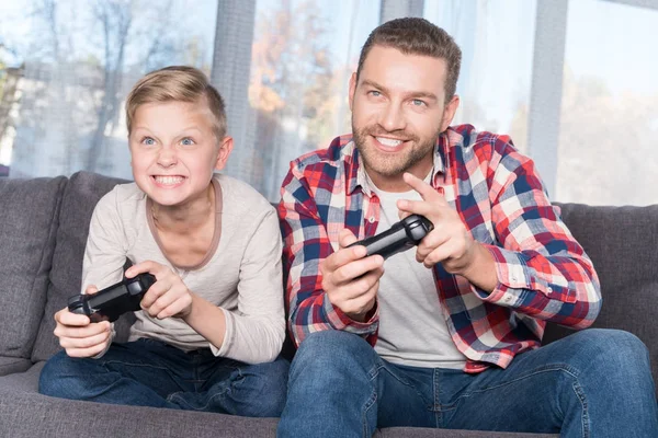 Far och son leker med joysticks — Stockfoto