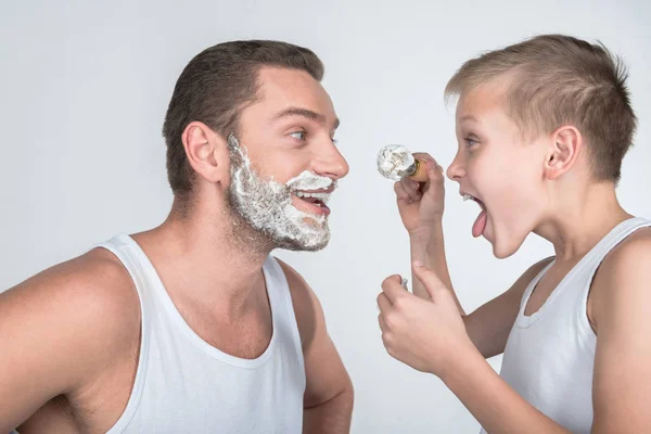 Father and son shaving together — Stock Photo, Image