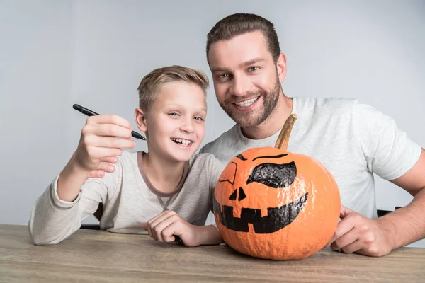 father and son with halloween pumpkin