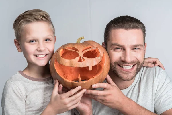 Far och son med halloween pumpa — Stockfoto