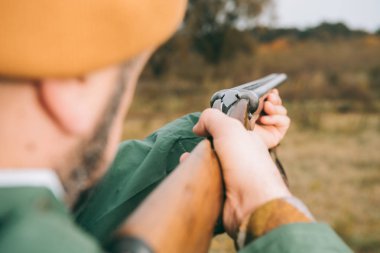 man aiming at something with gun clipart