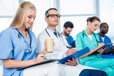 doctors listening to lecture and writing clipart
