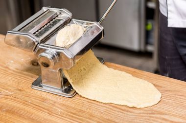 cropped image of chef preparing dough for pasta clipart