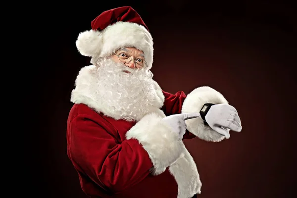 Santa Claus pointing on smart-watch — Stock Photo