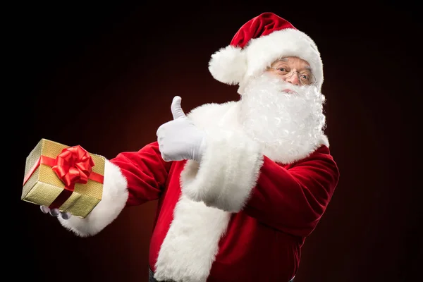 Père Noël avec boîte cadeau à la main — Photo de stock