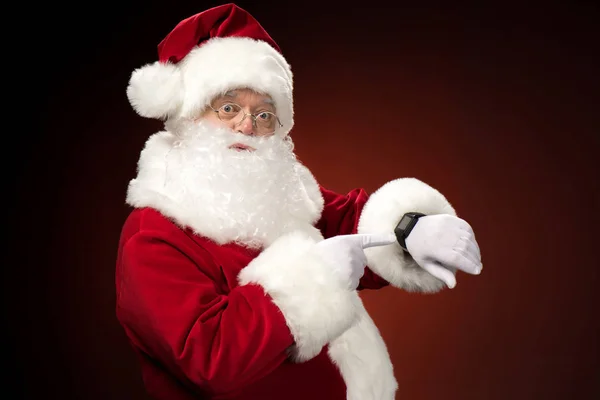 Santa Claus pointing on smart-watch — Stock Photo