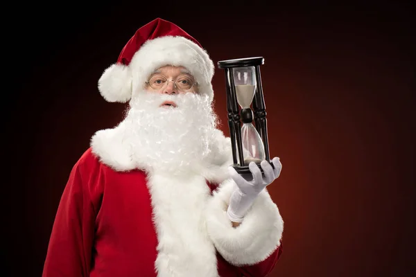 Santa Claus showing hourglass — Stock Photo