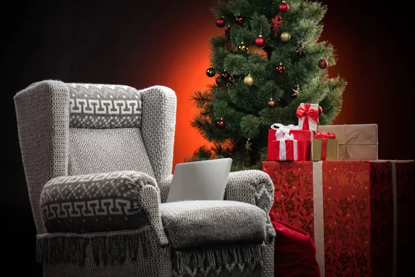 Armchair with gift boxes and fir-tree — Stock Photo