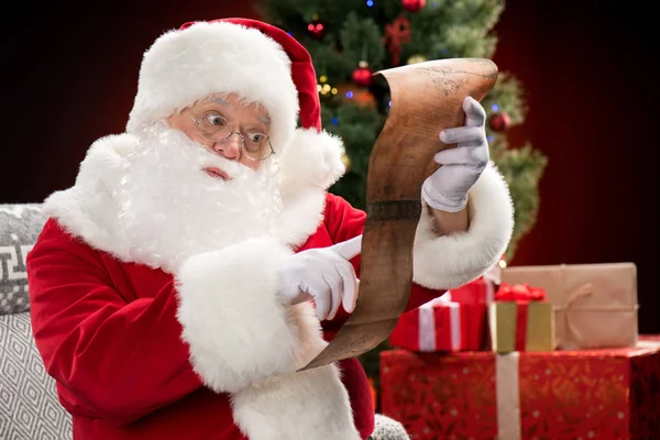 Santa Claus reading wishlist — Stock Photo