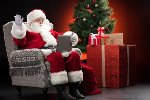 Santa Claus using laptop and gesturing — Stock Photo