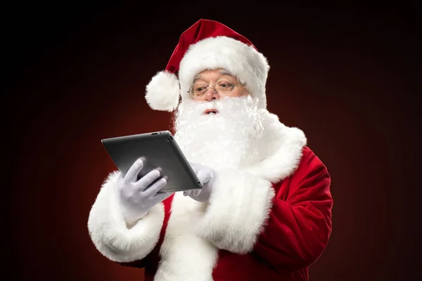 Santa Claus with digital tablet — Stock Photo
