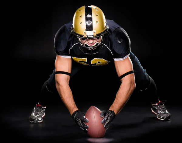 American football player holding ball — Stock Photo