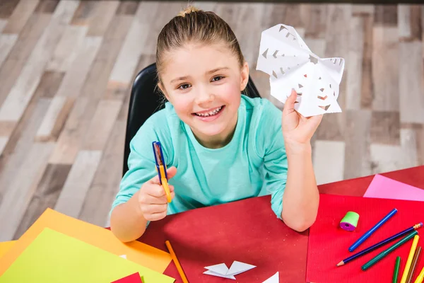 Schoolchild cutting paper — Stock Photo