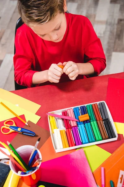 Schoolchild playing with plasticine — Stock Photo